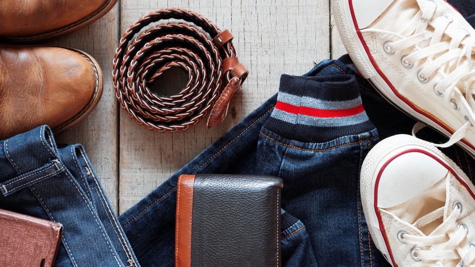 Kläder, skor och accessoarer på trägolv/Clothes of jeans and accessories on an old wooden floor.