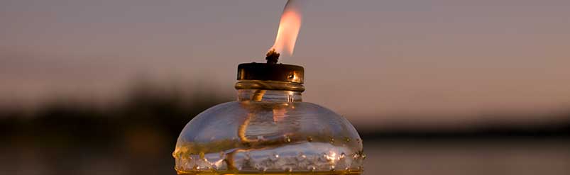 Picture of an oil lamp with its burning flame.